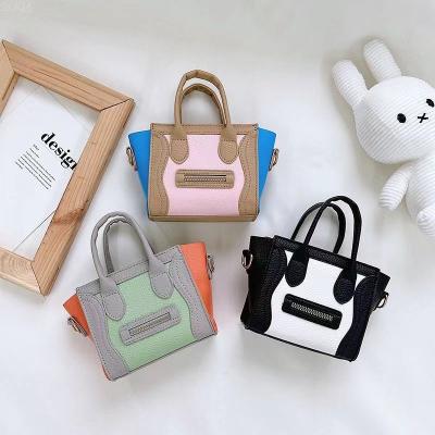 China 2022 Fashion Trend Waterproof Custom Kids Clips Western Style Little Girl Clips Handbags Cute Smiling Face Cross - Body Bag For Kids for sale