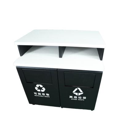 China Equipment is shown on the counter. Wholesale Custom Throw Trash New Arrivals Two Compartment Shopping Mall Trash Can for sale