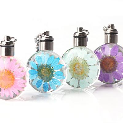 China Souvenir Gifts Promotion Cheap Real Glass Dry Luyun Flower Glowing Led Key Chain With Light for sale