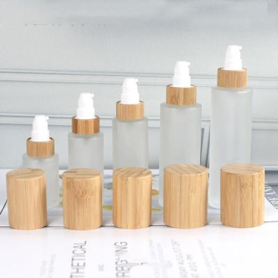 China 30ml 50ml 60ml 80ml 100ml 120ml Luxury Cylinder Shape Cap Lotion Pump Glass Frosted Bamboo Bottle for sale