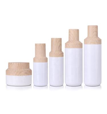 China Luxury Matte Custom Lotion Bottle Cosmetic Bottle Cream Jar Lotion Pump Spray Bottle With Wood Grain Cap for sale