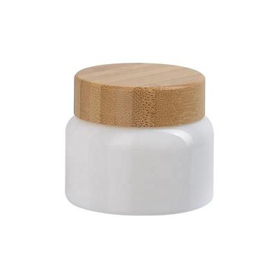 China 50ml Opal White Curved-Shape Cosmetic Jar 50g Opaque Glass Skin Care Face Cream Cosmetic Jars With Bamboo Wood Lid for sale