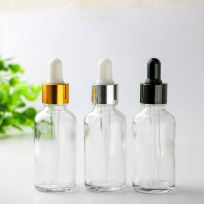 China Personal Care Cosmetic Packaging Transparent Glass Bottle Dropper With Silver Dropper Cap for sale