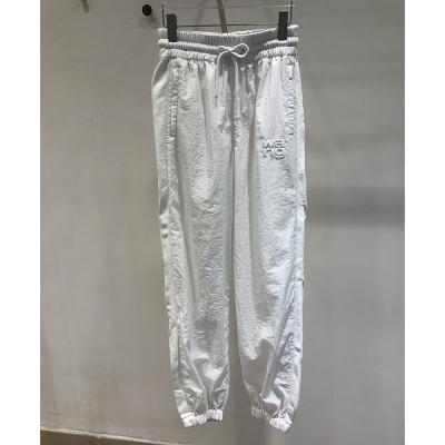 China New Spring Letter Anti-wrinkle Printing Soft Elastic Drawstring Waist Casual Harem Pants for sale