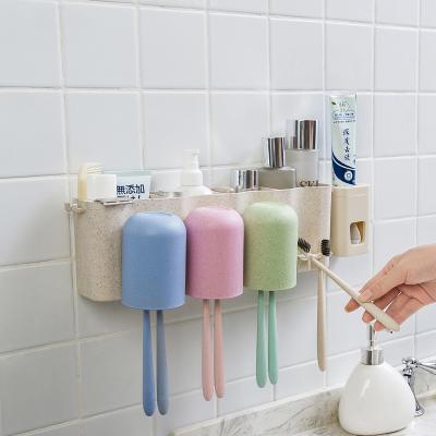 China Viable Multifunctional Plastic Wall Mounted Bathroom Toothbrush Holder Cup Set Toothpaste Dispenser Toothbrush Holder With Suction Cup for sale