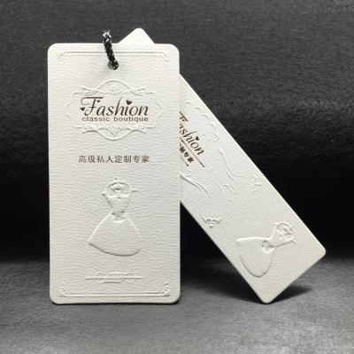 China Sustainable Manufacturer Fashion Embossed Garment Paper Hanger Tag for sale