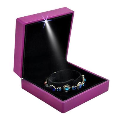 China Best selling plastic bracelet jewelry display box, luxury purple rubrones plastic bracelet box with led spotlight for sale