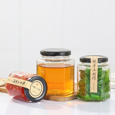 China Empty Honey Jar Glass Jar Hot Sale Luxury Honey Bottle Wholesale Unique Hexagon Custom Packing Heatable With Gift Box Foam Carton for sale