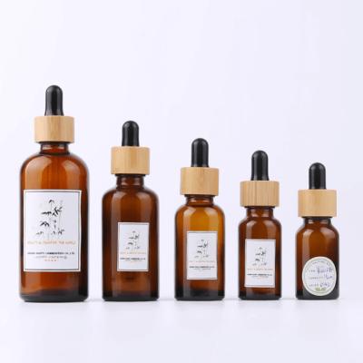 China 0.34oz 10ml Amber Glass Essential Oil Dropper Bottle With Eye Dropper Bamboo Cosmetic Bottles for sale