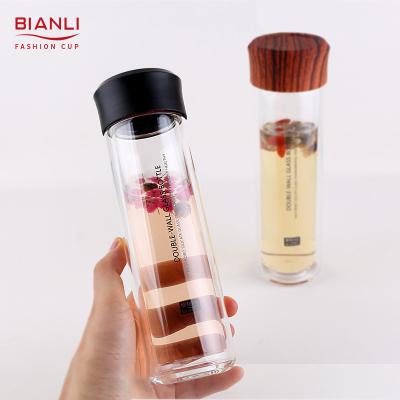 China Portable Custom Glass Tumbler Drinking Bottle Water Viable Borosilicate Motivational Drinking Juice Milk Screw Wooden Lid for sale