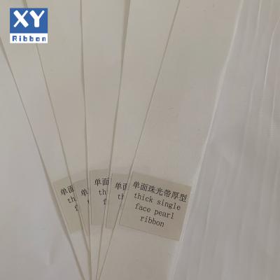 China Sustainable High Quality Single Sided Pearl White Polyester Taffeta Flat Ribbon For Apparel for sale