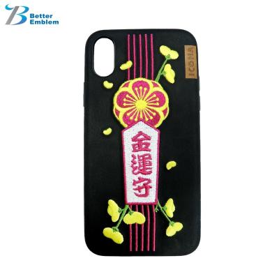 China Embroidered Garment Silver Charm Good Luck Phone Cases for sale