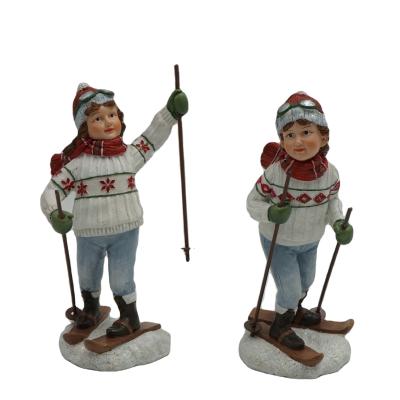 China New Design Polyresin Ornament Christmast Christmas Decoration Resin Boy Skiing Children And Girl Polyresin Figurine Poly for sale