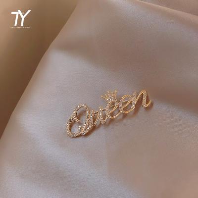 China New creative brooch in 2022 ALLOY letter queen Halloween crown brooches women Christmas party pins sexy badge for girls light proof for sale