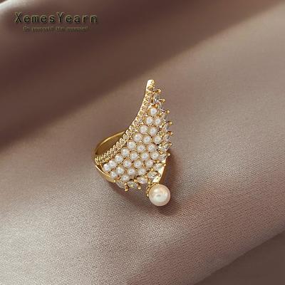 China 2022 FASHIONABLE new Luxury Zircon Wing Shape Gold Color Pearl Ring for woman is an uncommon accessory for Korean fashion jewelry party girls for sale