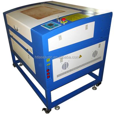 China Laser REDUCING signs technology 6040 CO2 60w laser cutting machine price cheap with knife aluminum table for sale