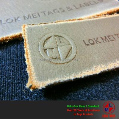 China 3D vintage and stained PU leather jeans label for sale