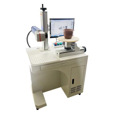 China Deep Marking Alaser Laser Engraving Machine Steel Engraving Machine with Rotary Disc for Pot Ceramic Cups Flower Parts Cylindrical Engraver for sale