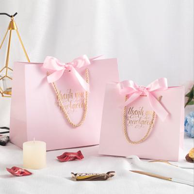 China Recyclable Luxury Paper Packaging Bags Pink Wedding Gift Bags Food Candy Bags Custom Shopping Logo for sale