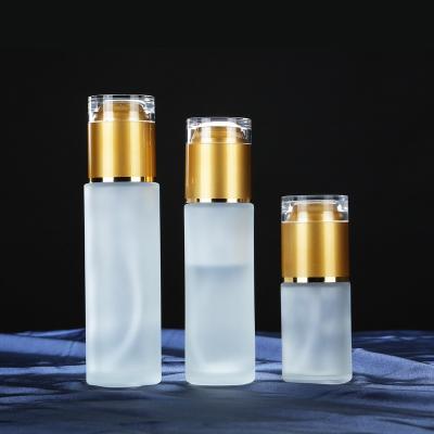 China Personal Care Order 60ml 80ml 100ml 120ml Cosmetic Pump Toner Round Empty Frosted Glass Lotion Bottles With Gold Bronze Cap for sale