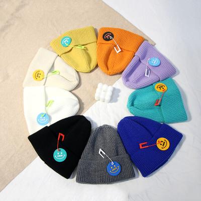 China New coming from COMMON 2021 9 colors stock wholesale smile rubber face beanie acrylic fisherman hats pins for sale