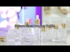 square clear glass bottle with gold dropper cap white silicone bulb packaging for serum oil cosmetic