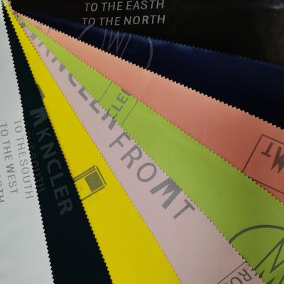 China Waterproof Release Paper PU Transfer Coating Fabric PU Coated 100%Polyester Fabric Printed 100%PU Down Jacket Fabric For Garment for sale