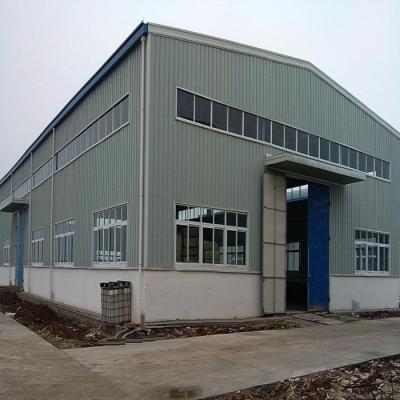 China Low Cost Prefab Industrial Warehouse Easy Assemble House Rock Wall Window Storage Roof Plastic Material Prefab Steel Wool Painted Slip for sale