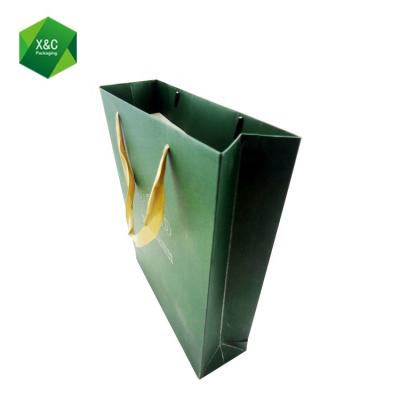 China Disposable Luxury Green Paper Emboss Craft Custom Shopping Tote Gift Bag for sale