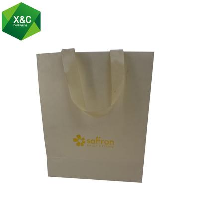 China Disposable High End Yellow Kraft Luxury Shopping Paper Bag Laminated Rope Handles With Gold Foil for sale