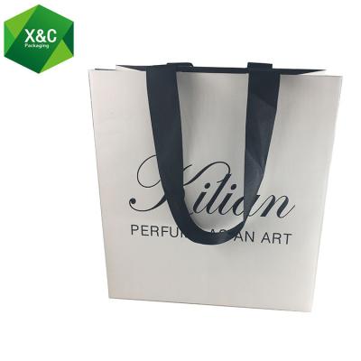 China Disposable Custom Print Embossed Shipping Perfume Kraft Tote Paper Bag Garment Manufacture for sale