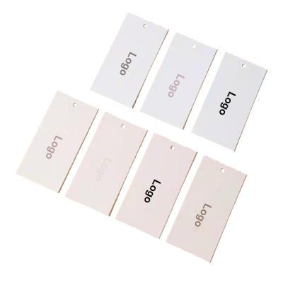 China Custom Factory Waterproof Logo White Matte Paper Clothing Embossed Custom Hang Tag Garment Labels Garment Accessories for sale