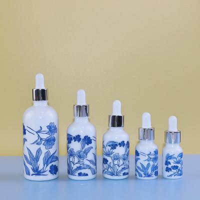 China 10ml 15ml 30ml 50ml 100ml Oil Cosmetic Packaging Round Shoulder Blue And White Ceramic Glass Bottle With Dropper In Stock for sale