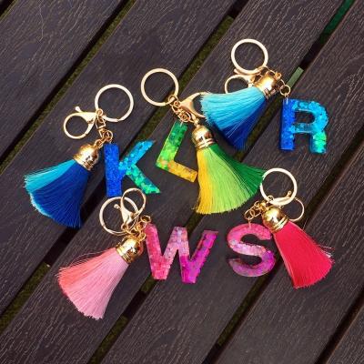 China Custom Resin Logo Gradient Rainbow Sequin Tassel Glitter Resin Initial Letter Key Chain for sale