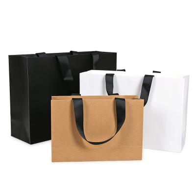 China Disposable Good Quality Luxury Design Custom Brown Kraft Paper Clothes Shopping Bags With Logo for sale