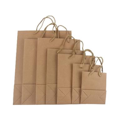 China Wholesale Disposable Heavy Duty Reusable China Brown Kraft Paper Shopping Handle Bag With Custom Logo for sale