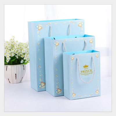 China Recyclable Customizable Printing Kids Birthday Party Cardboard Paper Embossing Blue Gift Bag With Logo for sale