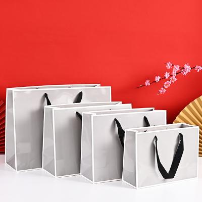 China Recyclable Luxury Customizable Printing Black White Cardboard Paper Gift Shopping Bag With Handle for sale