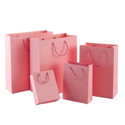 China Low MOQ Custom Good Quality UV Embossing Pink Reuseable Cardboard Apparel Gift Jewelry Gift Shopping Parcel Bags for sale