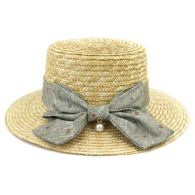 China Summer Bow Striped Straw Hat For Women Beach Wheat Straw Woven Straw Hat for sale