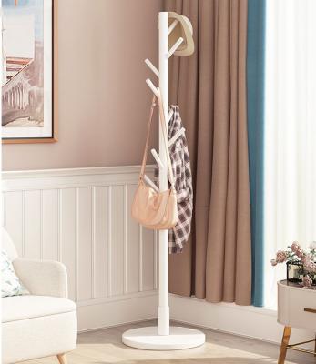 China Simple Household Rotary Entry Vertical Clothes Rack Small Solid Wood Floor Bedroom Hanger Bag Rack for sale