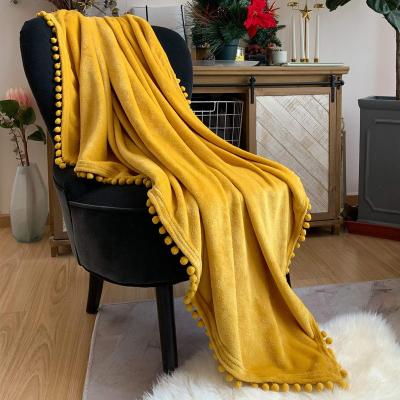 China Anti Dust Mites Flannel Blanket With Pompom Fringe Lightweight Comfortable Bed Blanket Throw Soft Fit Couch Suitable For All Season for sale