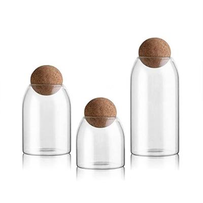 China Modern Wholesale 5 Pieces Glass Food Container Jars Set Wooden Food Glass Jar Cork Ball Stopper Lid for sale