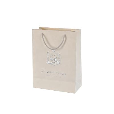 China Recycled Materials Wholesale Custom Luxury White Kraft Paper Bag Logo Print Recycled Clothing Paper Packaging Gift Bag With Your Own Logo for sale