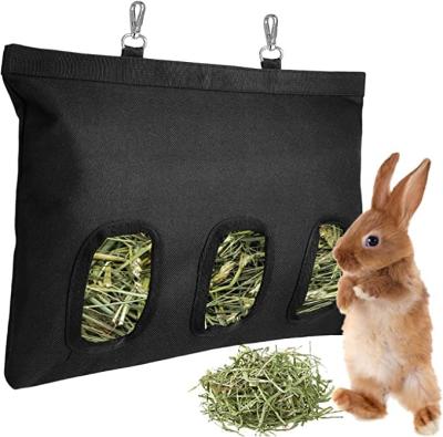 China Waterproof Rabbit Supplies Waterproof Adjustable Strap Hanging Slow Feed Hay Feeder Bag for sale