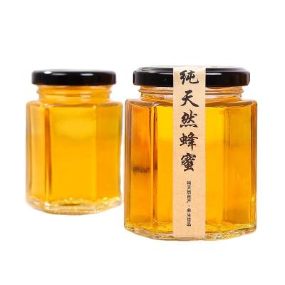 China Sustainable Hot Selling Clear Mixed Sized Honey Storage Hex Glass Jars With Black Metal Lids for sale