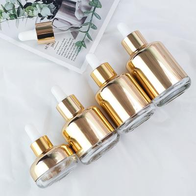 China Luxury Cosmetic Luxury Gold Plated Glass Essential Oil Dropper Bottle 20ml 35ml 50ml 55ml 70ml Glass Bottle With Rubber Dropper for sale