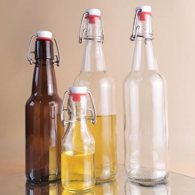 China Wholesale 125ml 350ml 500ml Beverage Clear And Amber Glass Beer Bottles For Brewing With Swing Cap Flip Cap And Silicone Airtight Seal for sale