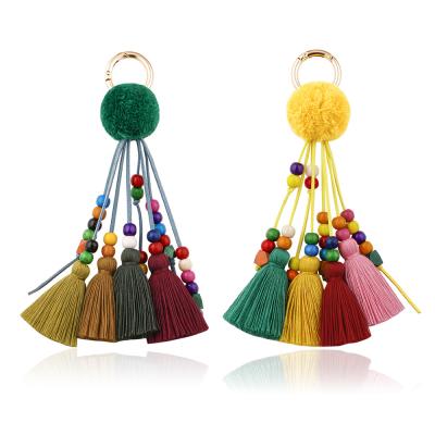 China Simplicity Colored Wooden Ball Tassel Hair Circle Pendant Alloy Key Chain Tassel Yarn Cotton Beads Dangling Key Chain for sale