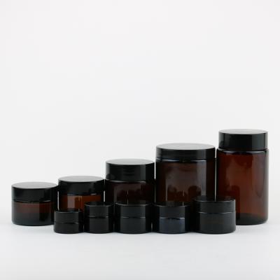 China Personal Care 15ml 30ml 50ml 60ml 125ml Brown Amber Cream Glass Jars Bottle With Black Lid for sale